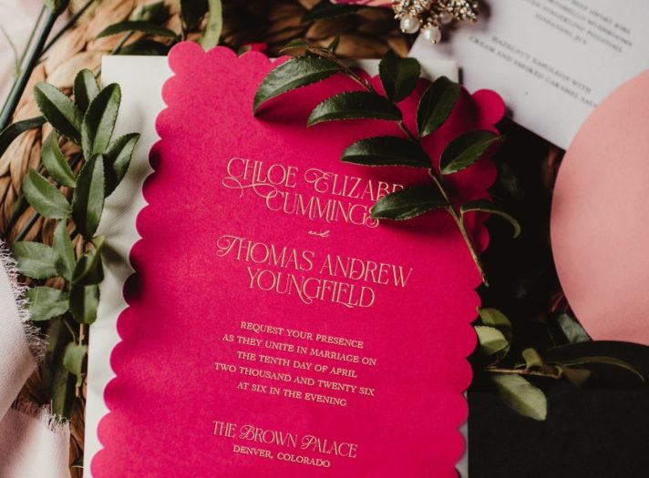 Hot pink scalloped-edge wedding invitation card, featuring elegant gold foil.